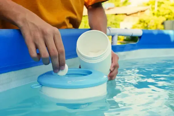 Houston pool owner adding chlorine 